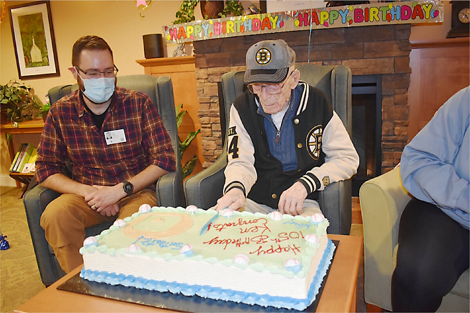Ken Dimond cuts his birthday cake as his grandson, Eric Staal, looks on. Photo by Terry Farrell