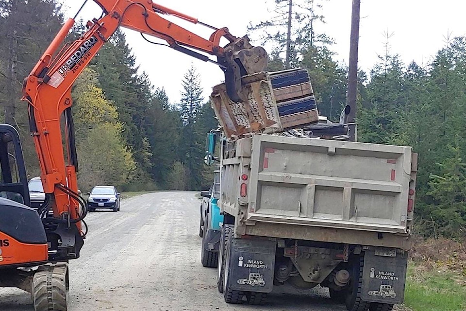 A crane was used to load trash on to a truck. (Submitted photo)