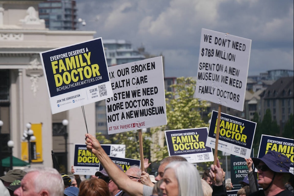 Dozens display signs at the BC Health Care Matters rally on May 19, 2022, at the legislature for World Family Doctor Day. (Evert Lindquist/News Staff)