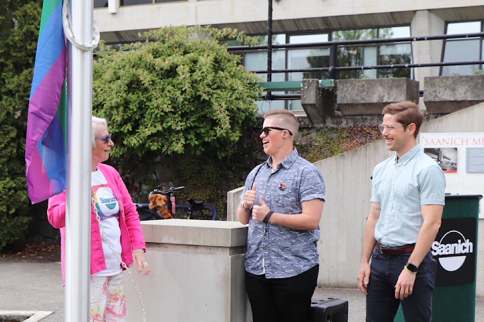 Acting Saanich mayor Coun. Karen Harper raises the rainbow flag June 1 marking Pride month in the municipality, joined by Victoria Pride Society president Britton Kohn and Inter-Cultural Association staffer Robin McGeough. (Don Descoteau/News Staff)