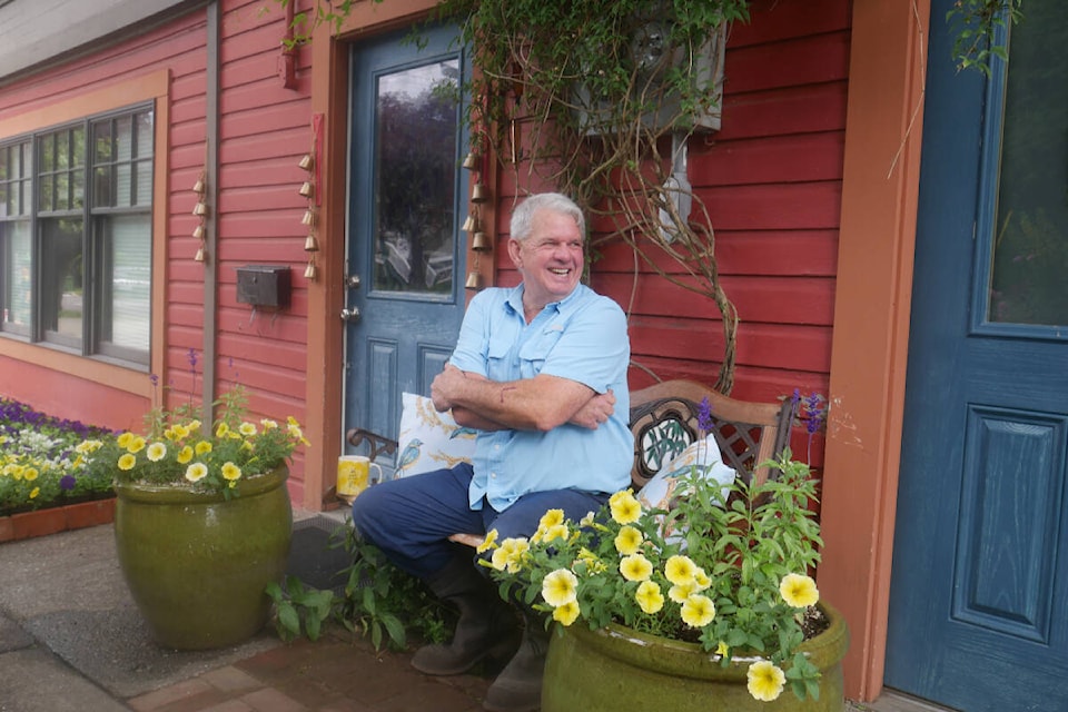 Sahasi Erven is pictured having a laugh by his garden at 2201 Chambers St. on July 8, 2022. (Evert Lindquist/News Staff)
