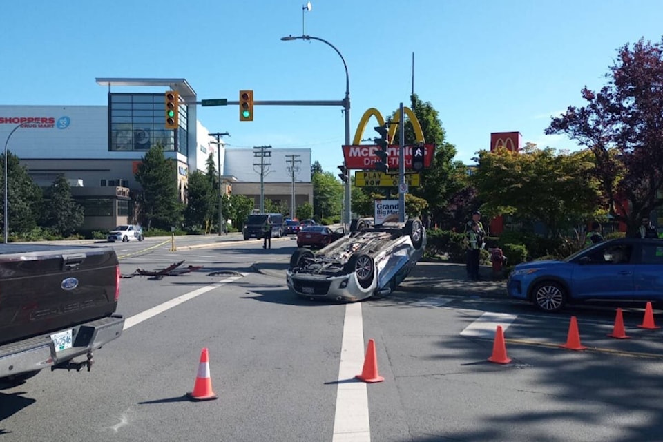 A car is shown flipped over by Uptown at Saanich Road and Oak Street on the morning of July 20, 2022. (Austin Westphal/News Staff)