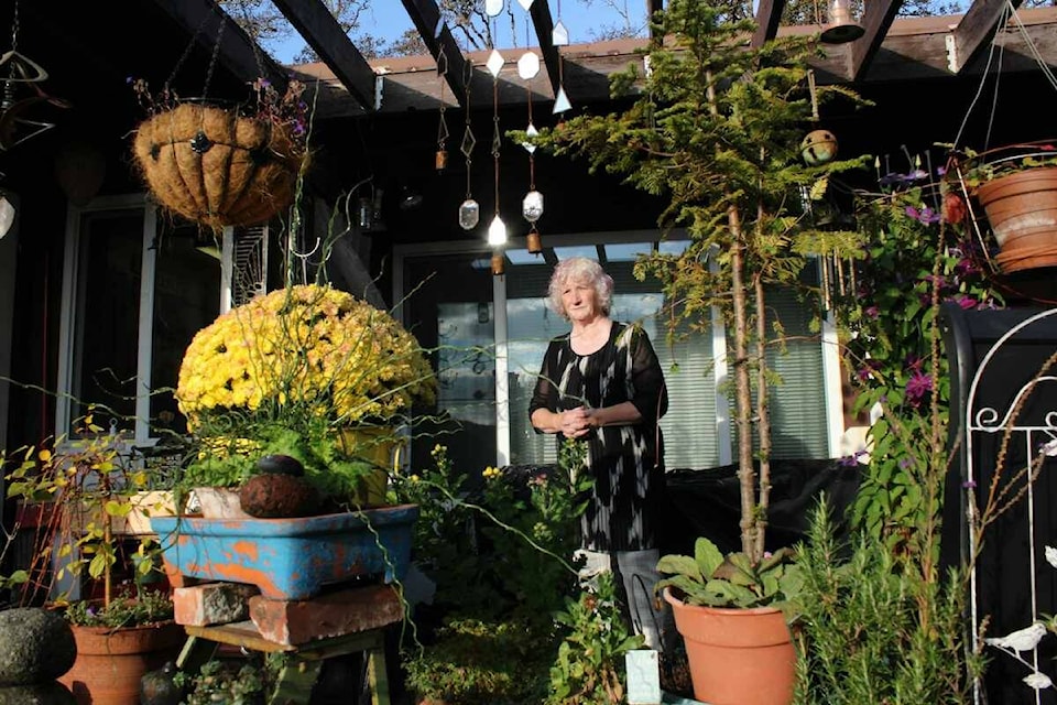 Peggy Flett, 67, stands outside her cottage at the Dawson Heights Housing Society in Saanich. She and other residents will have to move out by mid-winter as a new affordable housing project is set to replace the senior cottages. (Jake Romphf/News Staff)