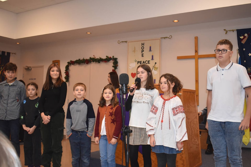 The children recited a Christmas poem fo an appreciative audience.