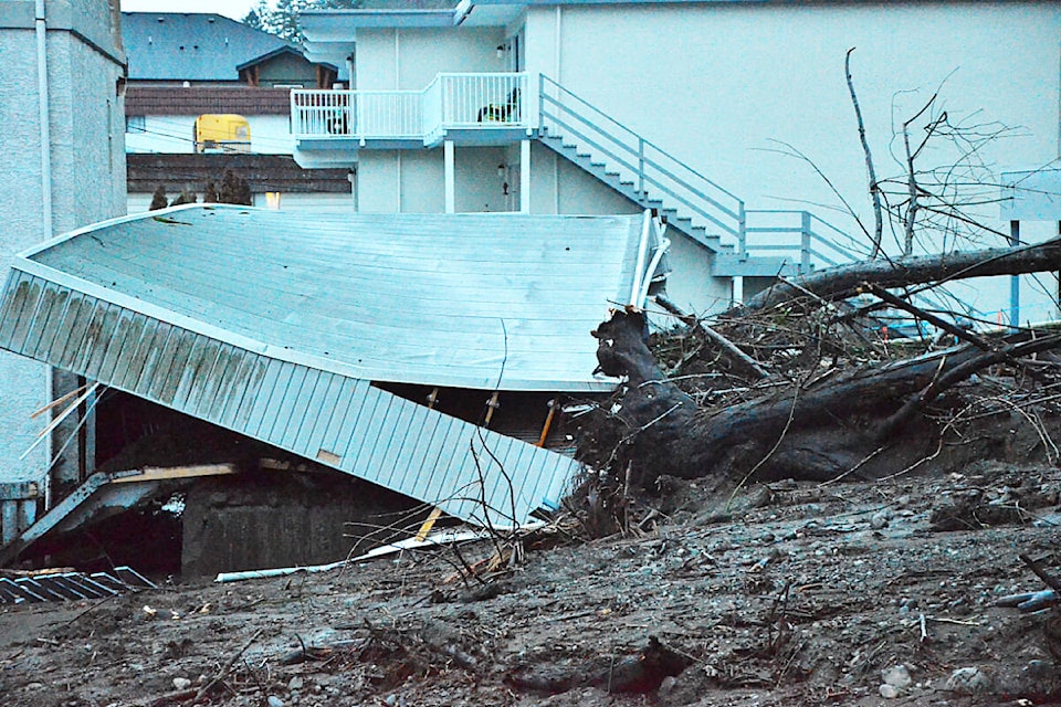 Roots, tree trunks and mud pile up against a parkade that collapsed in a mudslide at the 700 block of South Island Highway in Campbell River Tuesday, Jan. 17, 2023. Photo by Alistair Taylor/Campbell River Mirror