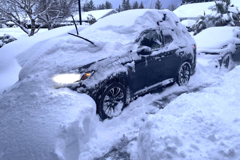 Residents find a foot of snow on their vehicles. (Michael Briones photo)