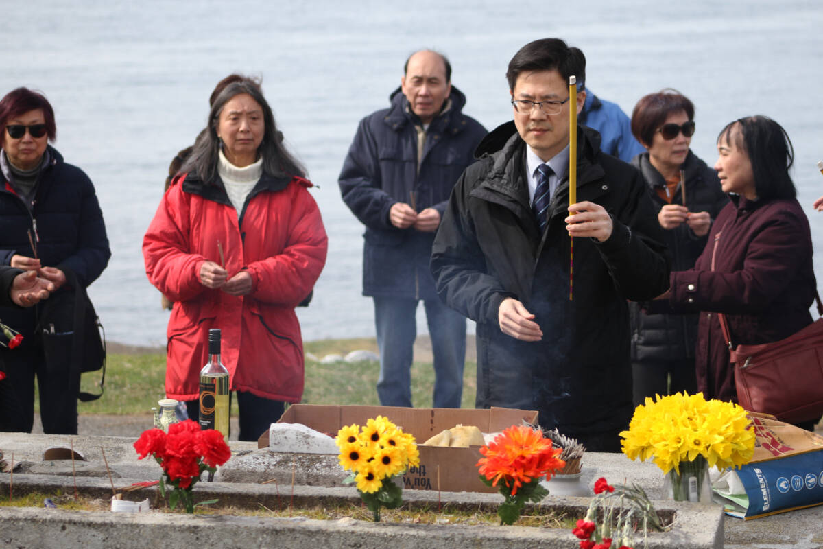 Members of Victorias Chinese diaspora community lay flowers and light incense in celebration of Qingming at the Chinese Cemetery at Harling Point in Oak Bay April 5. (Austin Westphal/News Staff)