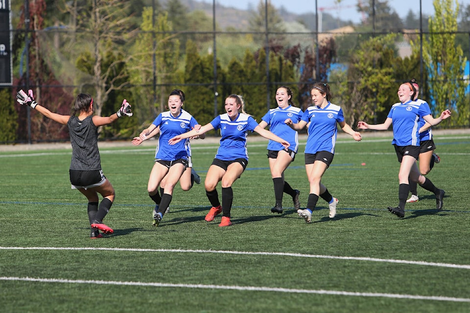 Players from Reynolds Secondary School run to celebrate winning the penalty shootout which secured victory in the senior girls’ soccer AAA Island championship final against Stelly’s Stingers on Tuesday (May 16) at Goudy Field in Langford. (Bailey Moreton/News Staff)
