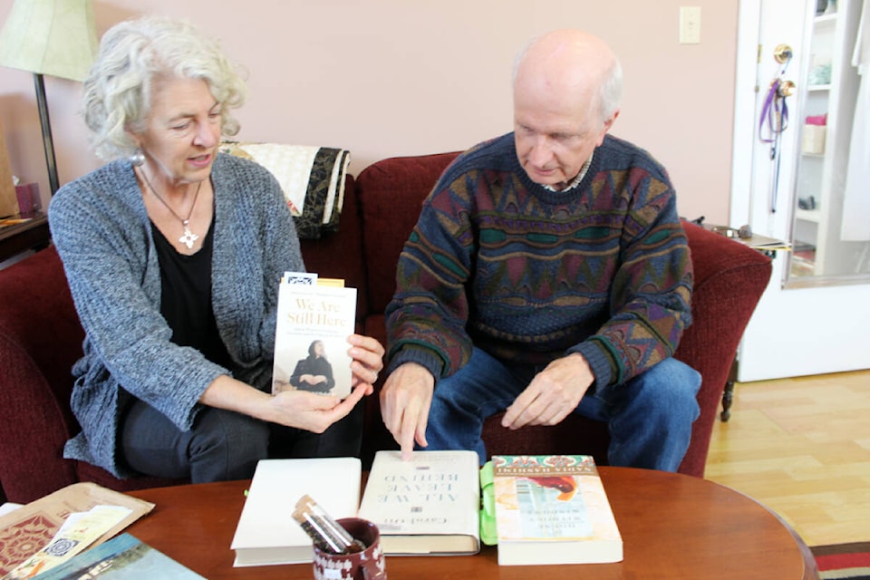 Elise Feltrin and Jim Tallman look over some of the reading material and information for an Afghani Afternoon on Sunday at the Chemainus United Church. (Photo by Don Bodger)