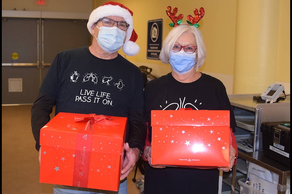 Steve Farmer (left) and Kathy Green (right) deliver boxes of popcorn to health-care professionals at Victoria General Hospital on Friday (Dec. 8). (Brendan Mayer/News Staff)
