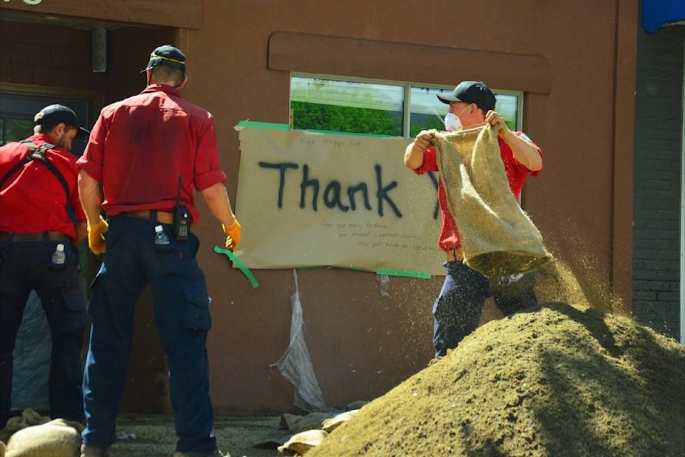 BC Wildfire firefighters empty sandbags as the threat of flooding recedes on Sunday. (Katya Slepian/Black Press Media)