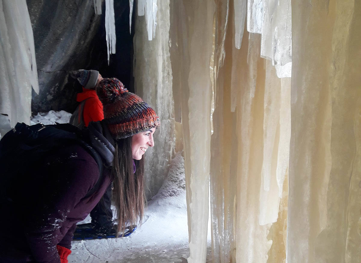 Enjoying the icicles behind a frozen waterfall.