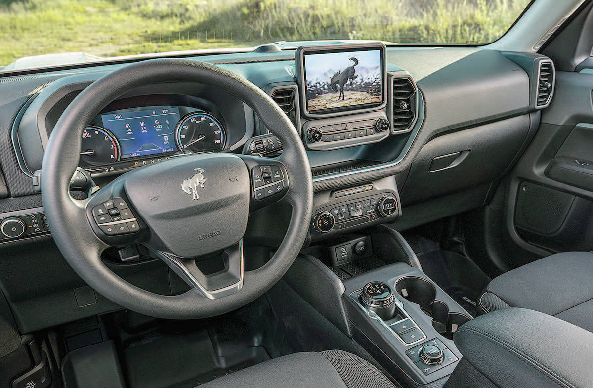 The squared-off exterior styling extends into the interior, where an eight-inch touch-screen is perched upright above the ventilation controls. The floor console is home to a gear-selector knob that replaces the traditional shift lever. PHOTO: FORD