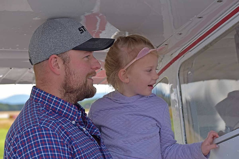 Phil Bouwman with his niece Claire Hauf, 5, explore some of the aircraft on display at the Vanderhoof Airport on Saturday, Sept. 11. (Rebecca Dyok photo)