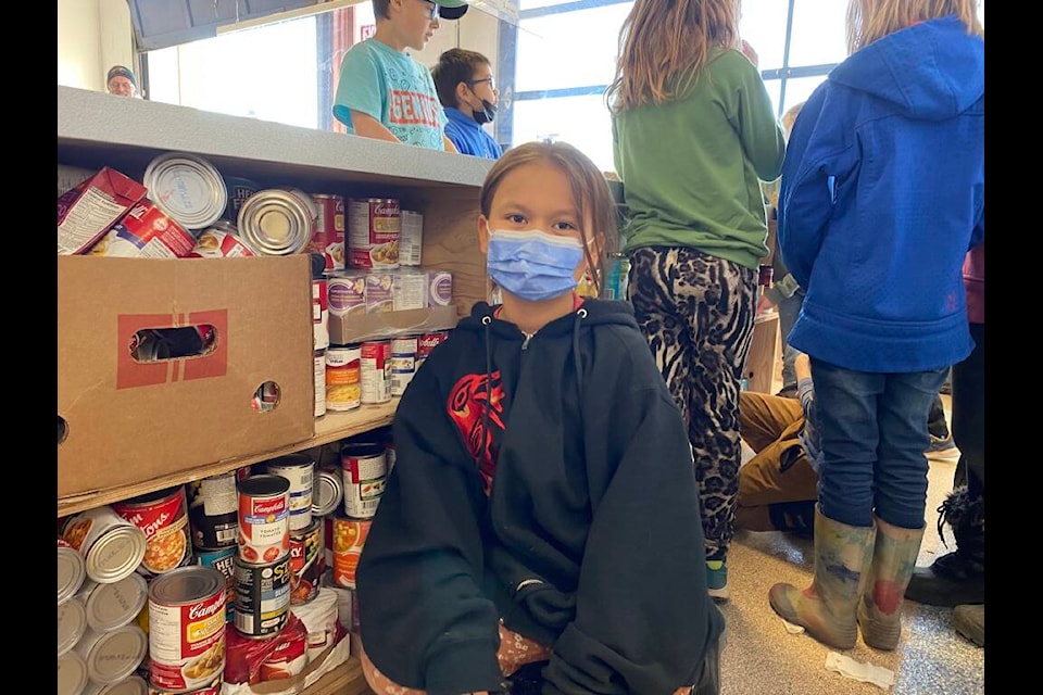 Annabelle, a Centennial Christian School student poses with cans of soup during the Grade 3 class visit to the Terrace Church’s Food Bank. (Submitted photo/Kelsey Merritt)