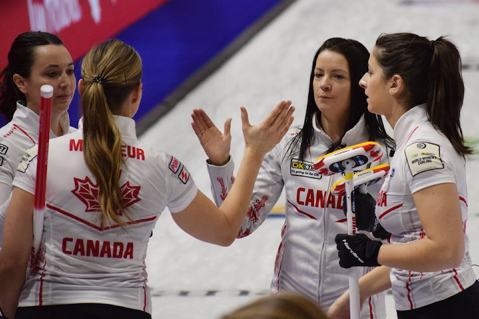 Team Canada high fives after defeating the United States at the World Women’s Curling Championship in Prince George on Thursday, March 24. (Tracey Roberts Photo - Quesnel Cariboo Observer)
