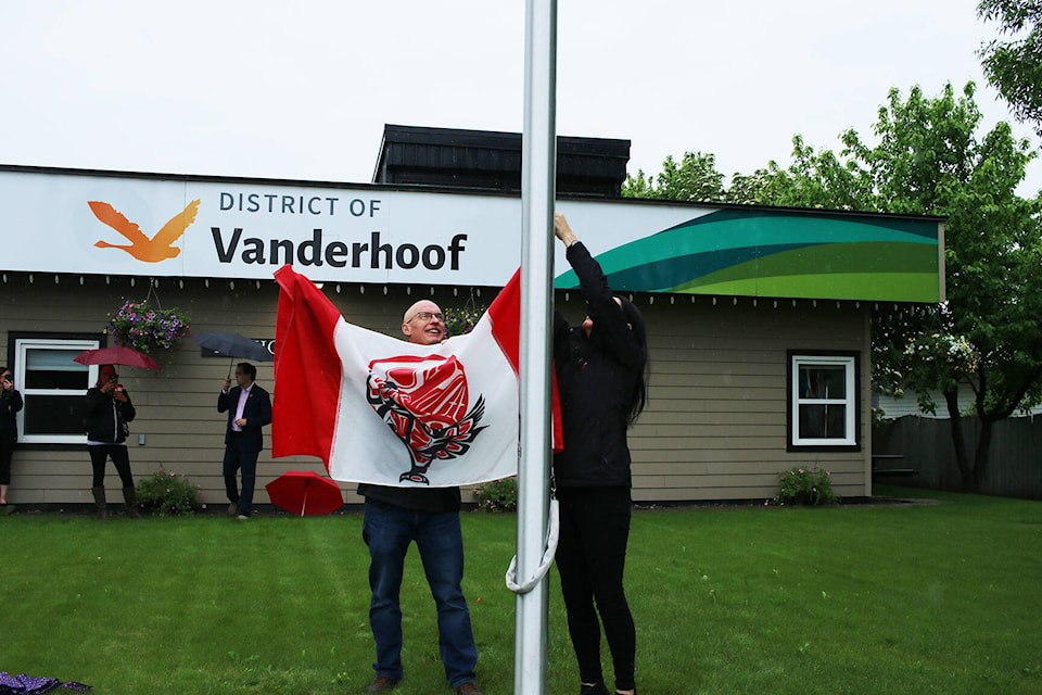 Vanderhoof Mayor Gerry Thiessen and Saik’uz First Nation Chief Priscilla Mueller get the flag ready to be hoisted in front of the municipal office. (Aman Parhar/Omineca Express)