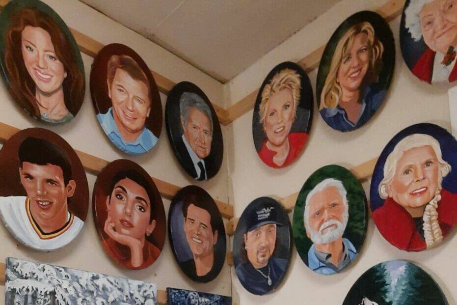 Merle Turner with the portraits of famous Canadians she painted on the wall. (Submitted photo)