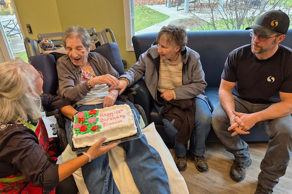 Vernon Heritage Square resident Blanche Schley (second from left) is all smiles on her 105th birthday Friday, Nov. 29, as she is presented with a cake from staff and family.