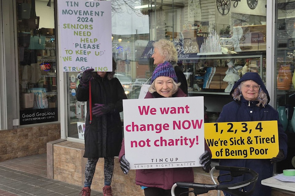 Susan Mark (left) and Doris Bensmiller braved a biting wind and cold temperatures to be among 10 or so seniors hitting the streets in Vernon Friday, Dec. 6. The group was protesting the federal government's plan to give $250 rebate cheques to Canadians making up to $150,000, and who worked in 2023. The rebate, however, does not apply to many seniors, recent graduates, and people with disabilities.