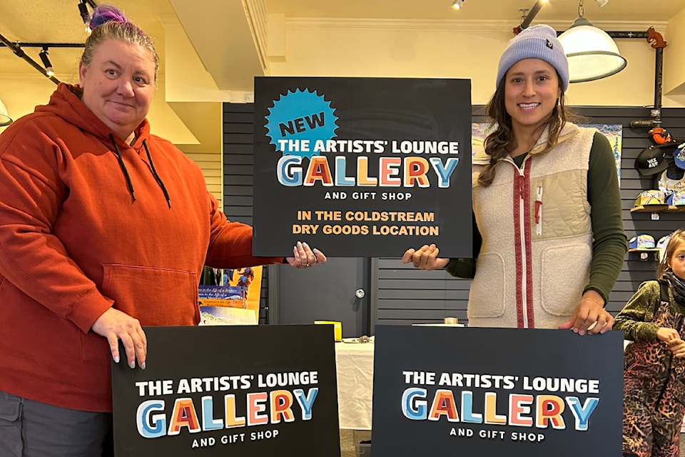 Lara Konkin (left) and Raffaella Vaz (right) with their new signs for the Artists' Lounge Gallery and Gift Shop at Silver Star Village. 