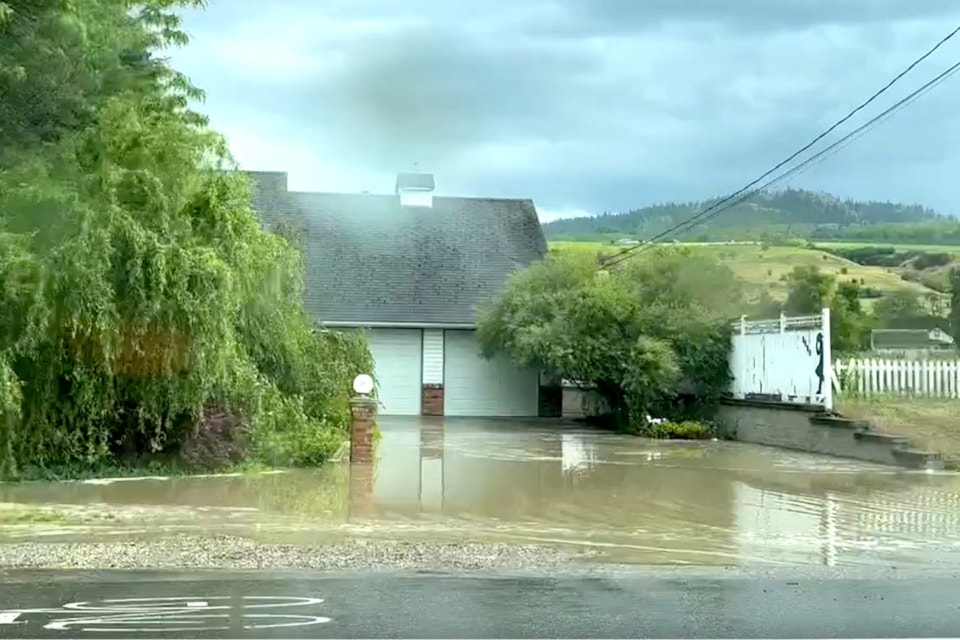 Water pools around an Okanagan Landing Road home Tuesday, July 2, 2024. 