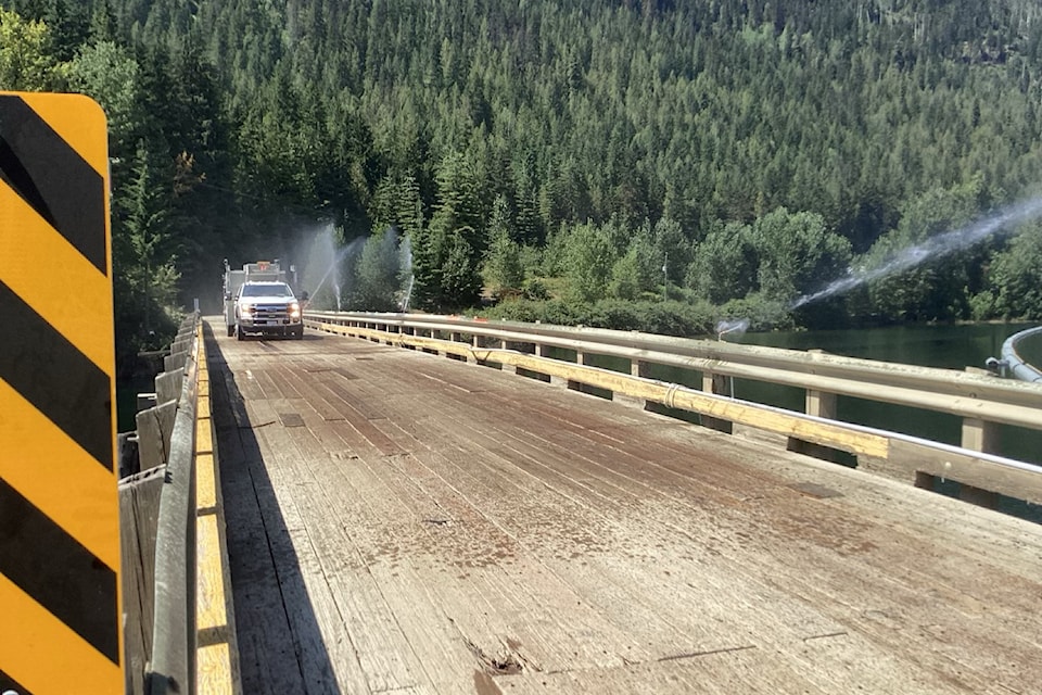 Sprinklers protect the wood Sugar Lake bridge from embers from the Sitkum wildfire.