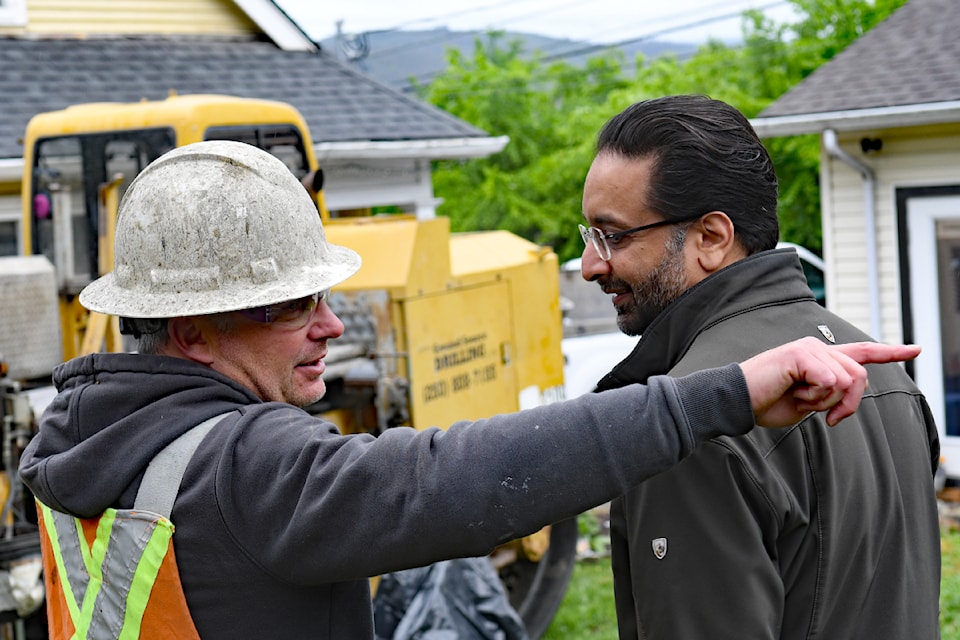 Scott Steward with Ground Source Drilling discusses the project with Amandeep Singh. 