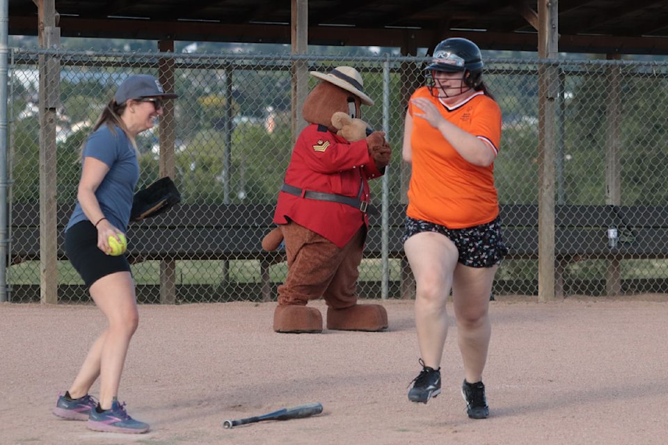 Vernon Special Olympics Tigers runner Katarina Czabelli (right) was just out at home plate as Vernon RCMP catcher Const. Krista Boudreau makes the play. Czabelli and the Tigers rallied to beat the RCMP 24-20 in a friendly softball game Thursday, June 20, at the Vernon Army Camp's Vic Rantio field.