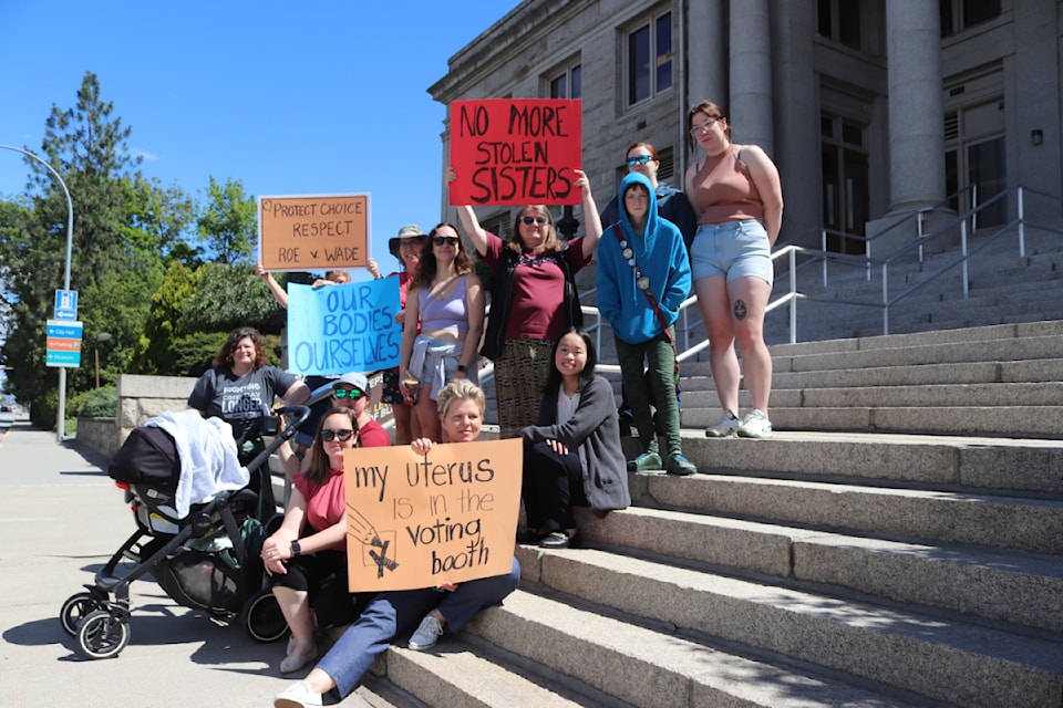 A group of North Okanagan women stand in protest of safety and bodily autonomy at the Vernon Courthouse Monday, June 24. 