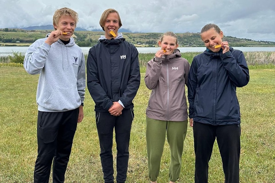 From left: Connor and Brayden Davis, Juliette and Naomi Fandrich, the new Lap the Lake course record holders with their Golden Oar medals.