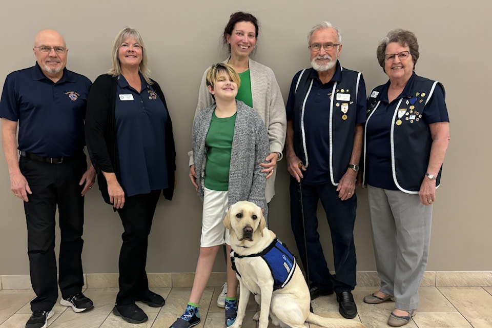 BC and Alberta Guide Dogs service dog instructor Holli Coward with Vernon Lions Club members Brian Barnett, Peggy Price, Ken Cain and Sharon Cain hand over a guide dog to Sophia, pictured with her mom Maggie on Friday, Nov. 1, 2024. The Lions Club was able to fund two service dogs for children on the autism spectrum in Vernon this year. 