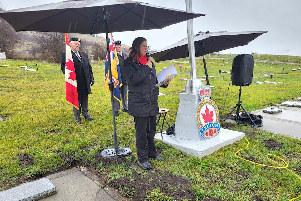 No Stone Left Alone event organizer/spokesperson Lawrna Myers begins the Lumby ceremony at the Lumby Cemetery Monday, Nov. 4. Joining Myers is the colour guard  of Rick Ritchey from the Lumby Legion (left) and Legion president Roy Turner.
