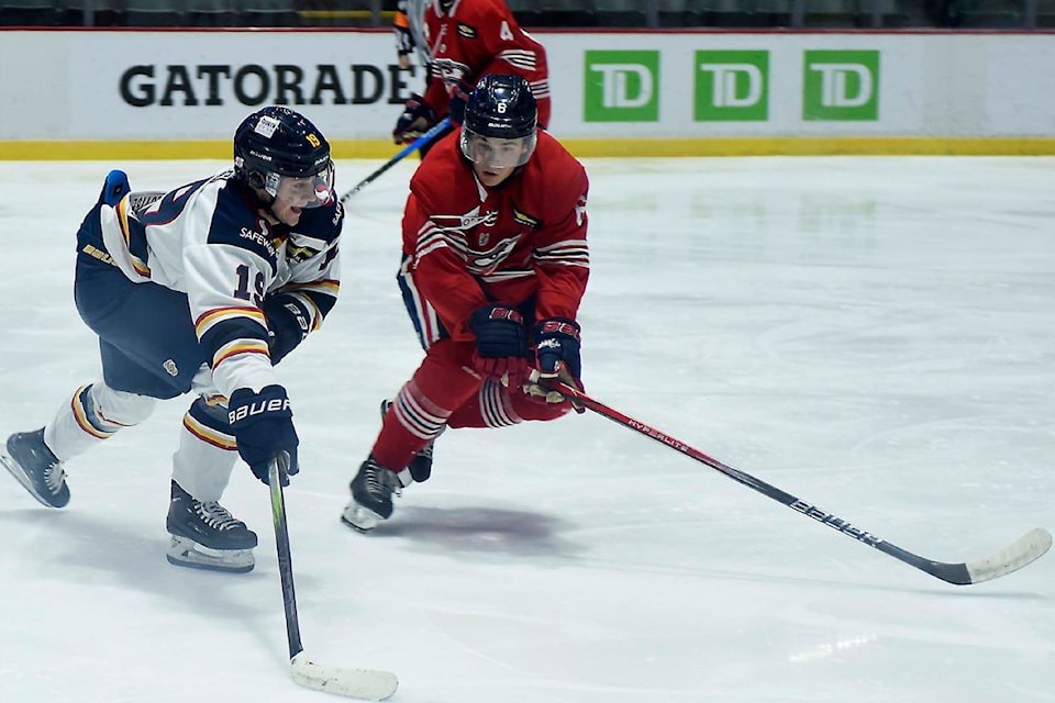 Vernon Vipers forward Charlie Kresl (left) tries to get by the check of Cowichan Valley defenceman Camden Charron during the Capitals’ 4-2 win over the Snakes at the B.C. Hockey League Showcase Event in Abbotsford. 