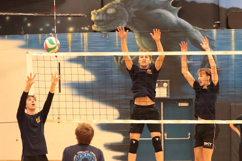 Kal Lakers co-captain Seth Hermanson (left) sets a ball away from would-be blockers Micah Snobelen (centre) and Jack Helfrick during a team practice. The Lakers will host the B.C. AA Senior Boys High School championships Nov. 27-30.