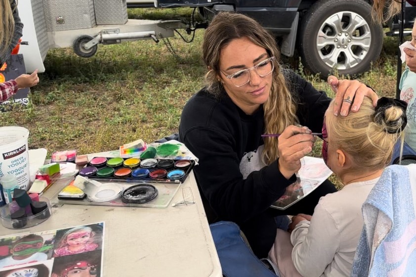 Kim Shippam of Caufield’s Engraving donates her time doing face painting at the Pumpkin Patch.