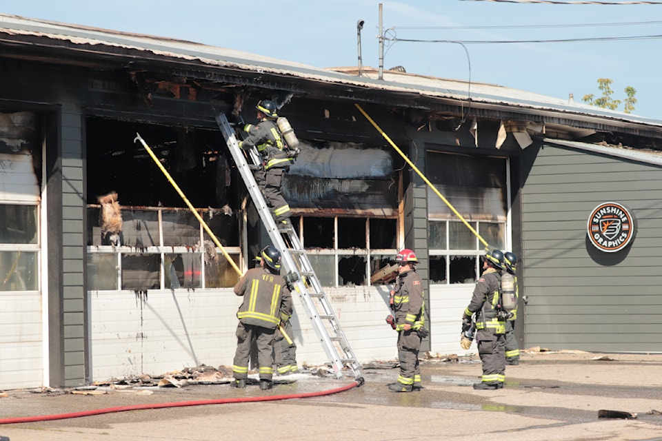 Firefighters put out hot spots at Sunshine Autographics Wednesday, Sept. 4, 2024. 