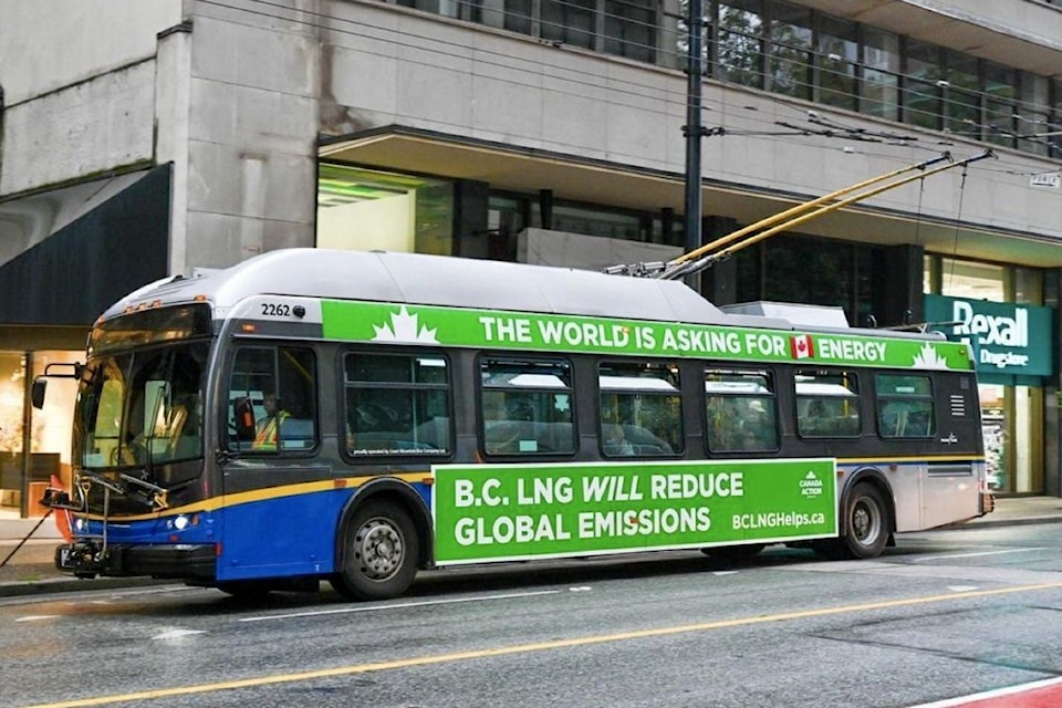 A transit bus is greenwashed with advertising. 