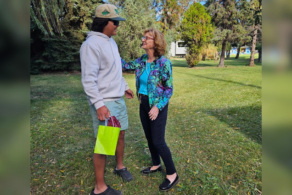 Margaret Penner, board president of the Okanagan Village Housing Society, and OKIB drummer Kacey Miller are all smiles after the announcement of a new affordable housing project in Vernon.