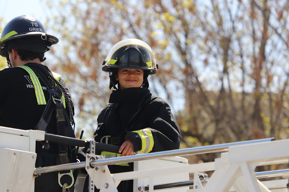 A female student takes a turn in the bucket of the Vernon Fire Rescue Services ladder truck during a Firefighter for a Day training session Wednesday, April 23, 2025. 