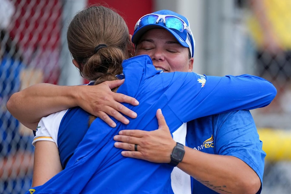 Vernon's Michelle Webster (right) hugs a fellow coach after Team B.C. defeated Ontario 9-6 to win gold in women's softball at the Canada Summer Games in Newfoundland and Labrador.