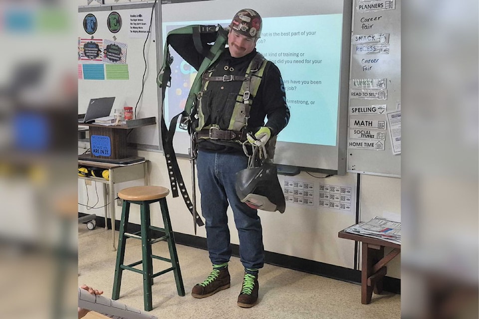 Red Seal ironworker Clay Veenstra shows some of the tools of his trade to students at Armstrong's Highland Park Elementary during the school's first-ever Career Fair Friday, Feb. 7.
