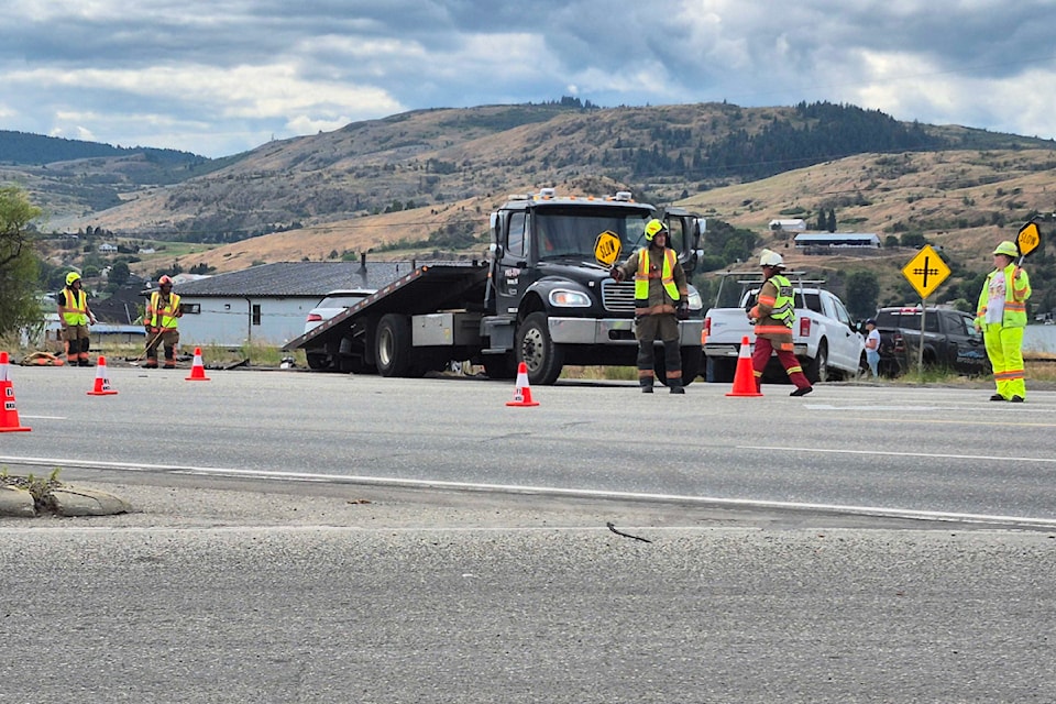 Crews clean up a two-vehicle crash on Highway 97 at Meadowlark Road July 17.