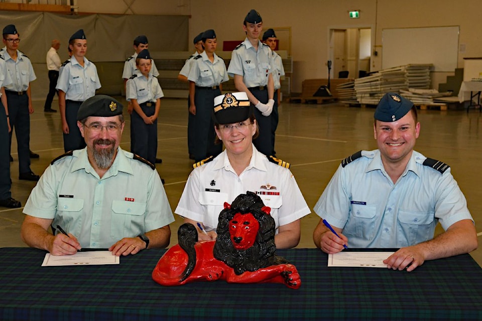 Signing the Change of Command documents transferring the leadership of 223 Red Lion Squadron are, from left: outgoing Commanding Officer Capt. Jason Paas, Commander Paula McHale, Regional Cadet Support Unit Commanding Officer and incoming Commanding Officer Capt. Ben Noorduyn. 