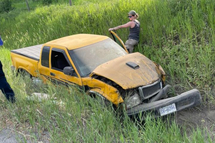 A truck sits in the ditch after crossing the centre line and crashing with another vehicle near Lumby June 11.
