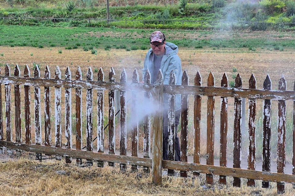Volunteer Kurtis Riese pressure washes some of the old paint off the picket fence at the O'Keefe Ranch  cemetery behind St. Anne's Church Monday, June 23.