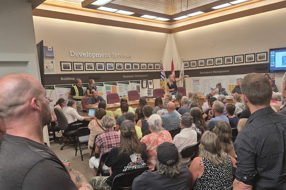 Township of Spallumcheen Mayor Christine Fraser (standing, centre) conducts business at a townhall meeting Monday, Aug. 18, regarding traffic at McLeod Road subdivision and Highway 97A.