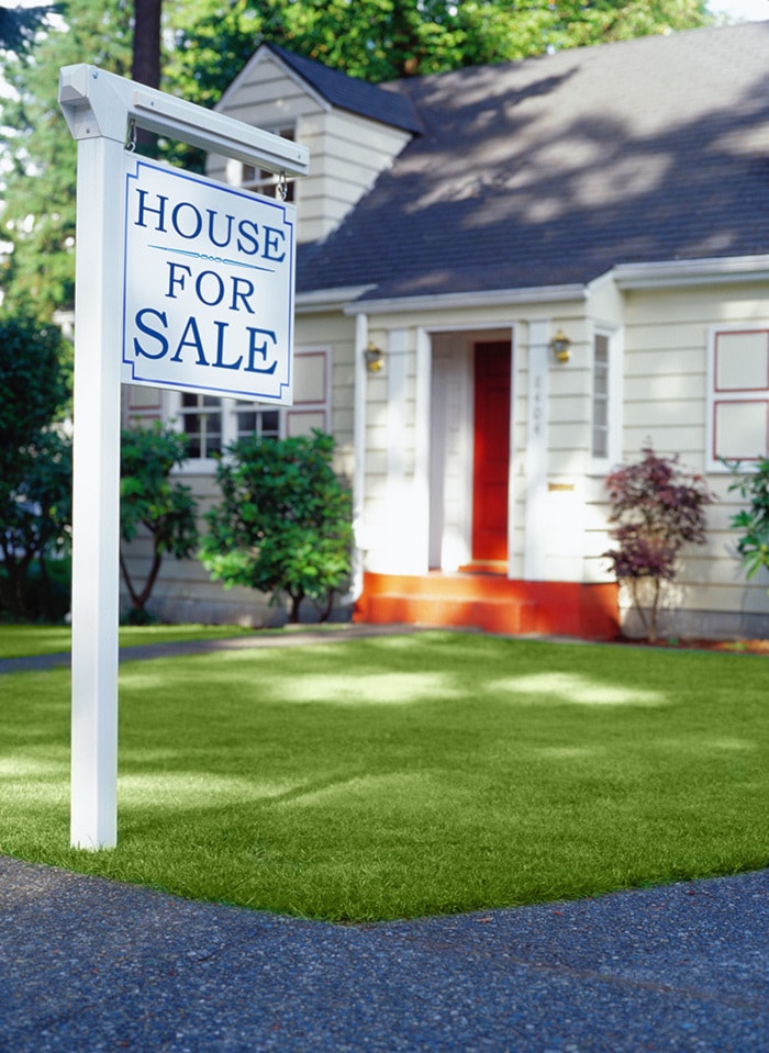 For Sale Sign in Front of a House