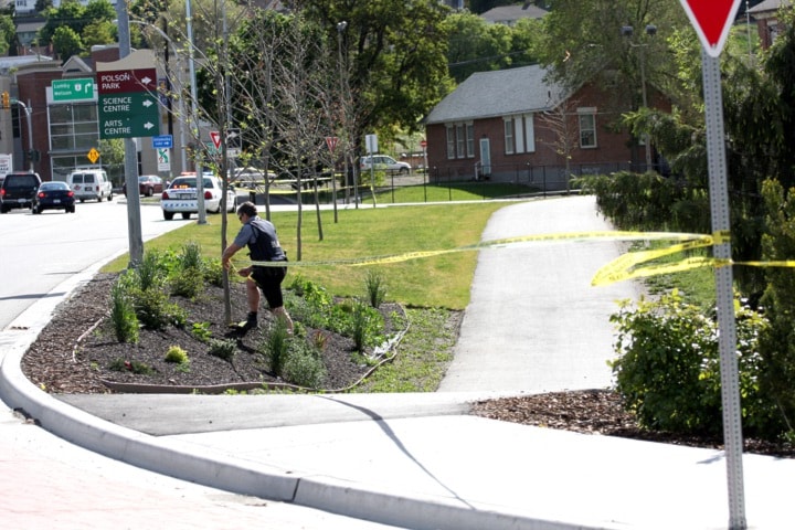 A City of Vernon bylaw officer tapes off the entrance to Polson Park.