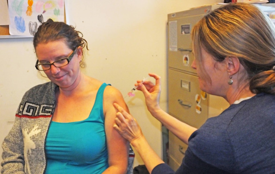 9826496_web1_Flu-shot-Stacy-paper